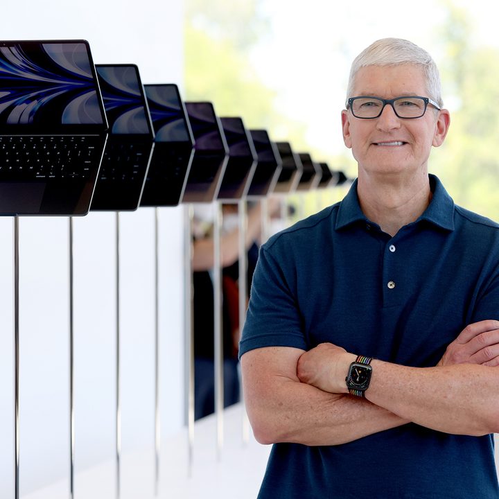 Apple CEO Tim Cook looks at a display of brand new redesigned MacBook Air laptop during the WWDC22.