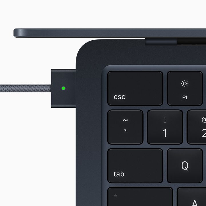 A top view of the M2 MacBook Air showing its keyboard and MagSafe charger.