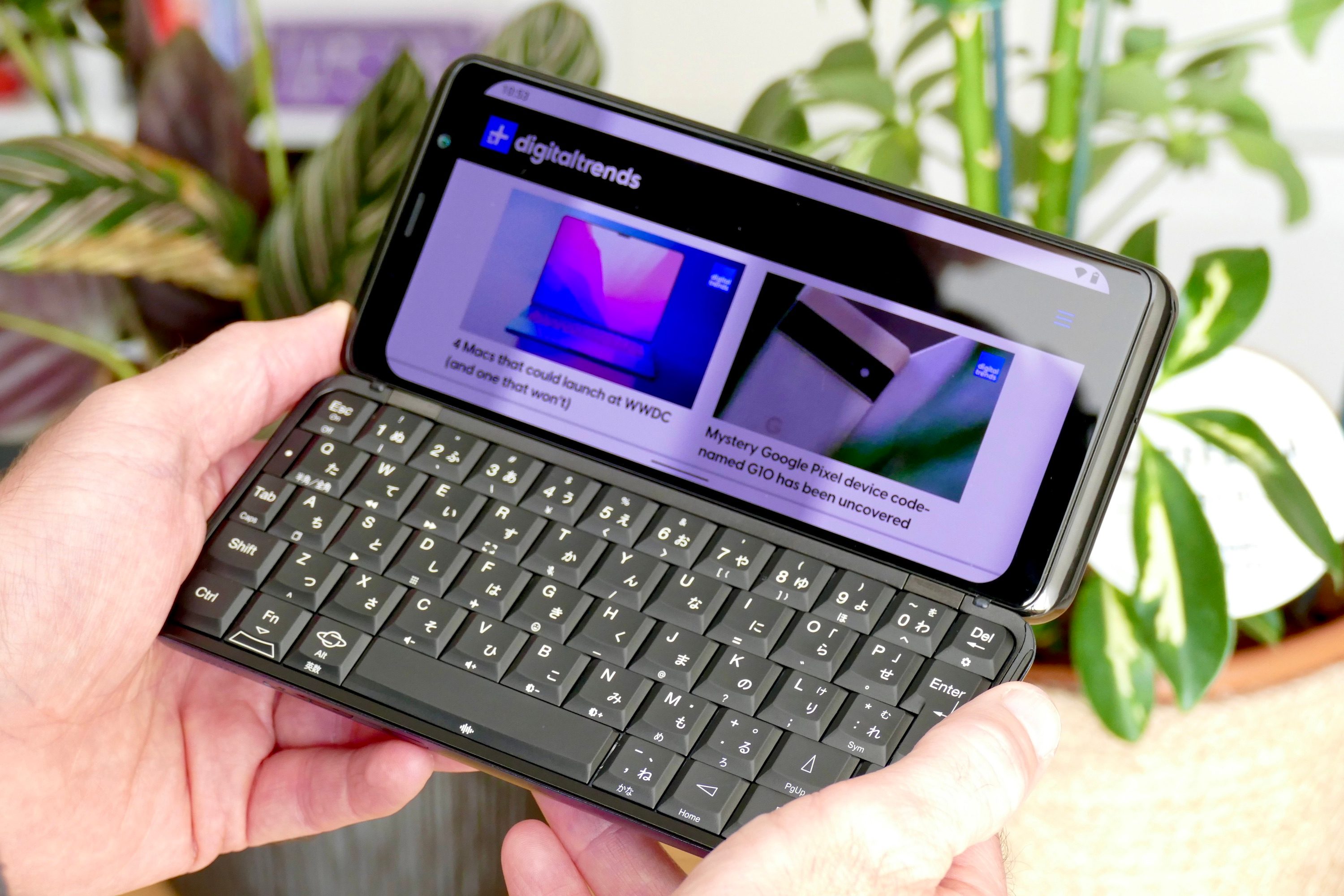 The Planet Computers Astro Slide 5G held in a man's hand.