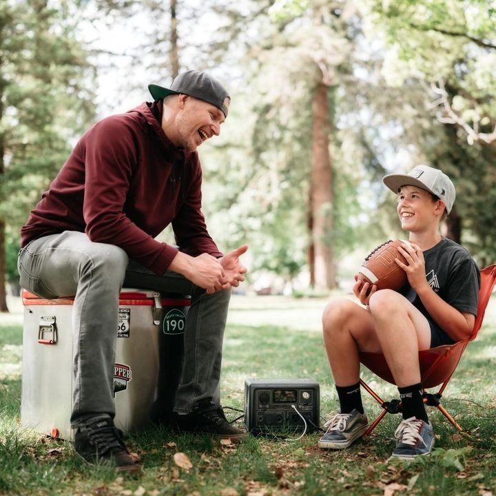 A man and boy use Bluetti EB3A Solar Generator with smart power management during an outdoor adventure.