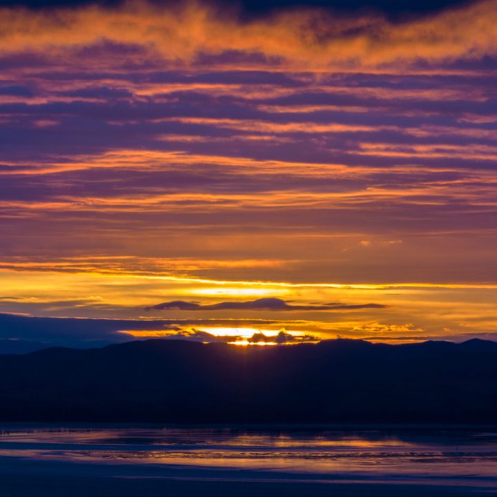A vibrant sunrise over a mount range.