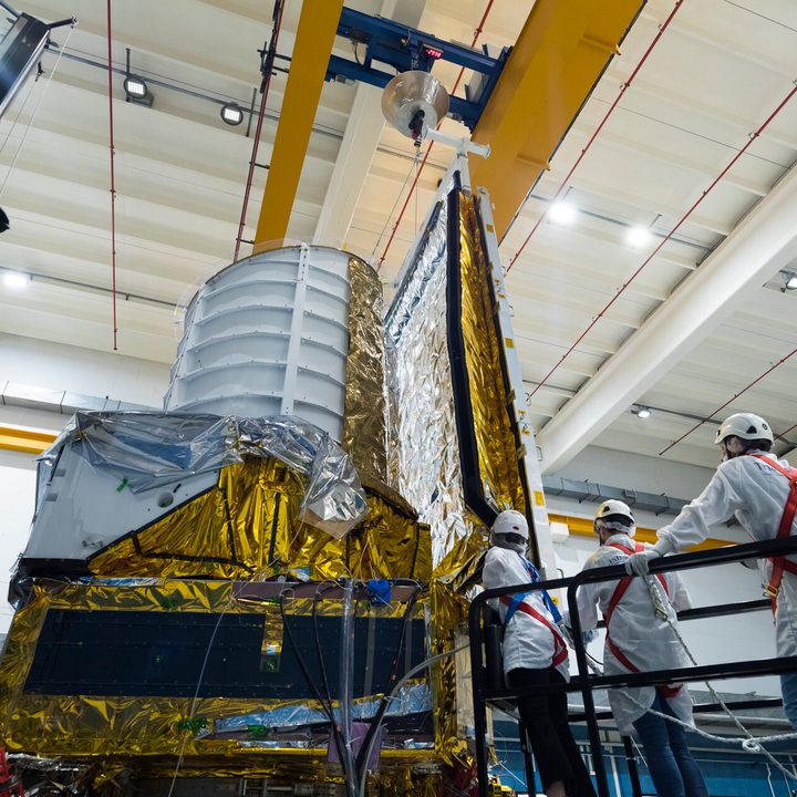 Engineers at Thales Alenia Space in Turin are attaching a combined sunshield and solar panel module to the main body of ESA’s Euclid spacecraft.