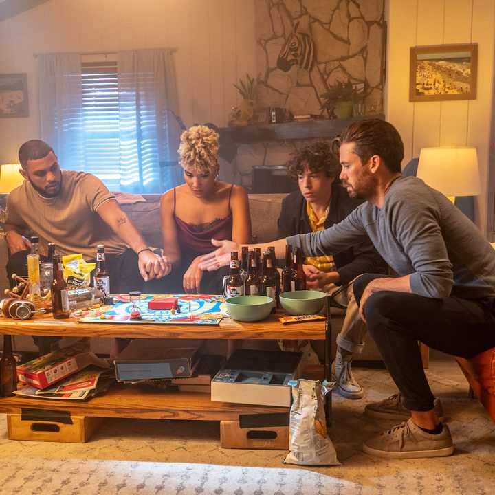 Cliff, Troy, Sam , and Paul sitting at the table in a scene from Gatlopp.
