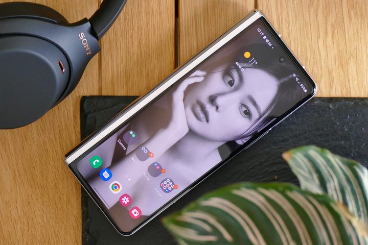 The Galaxy Z Fold 3 on a table, showing wallpaper on the outer screen.