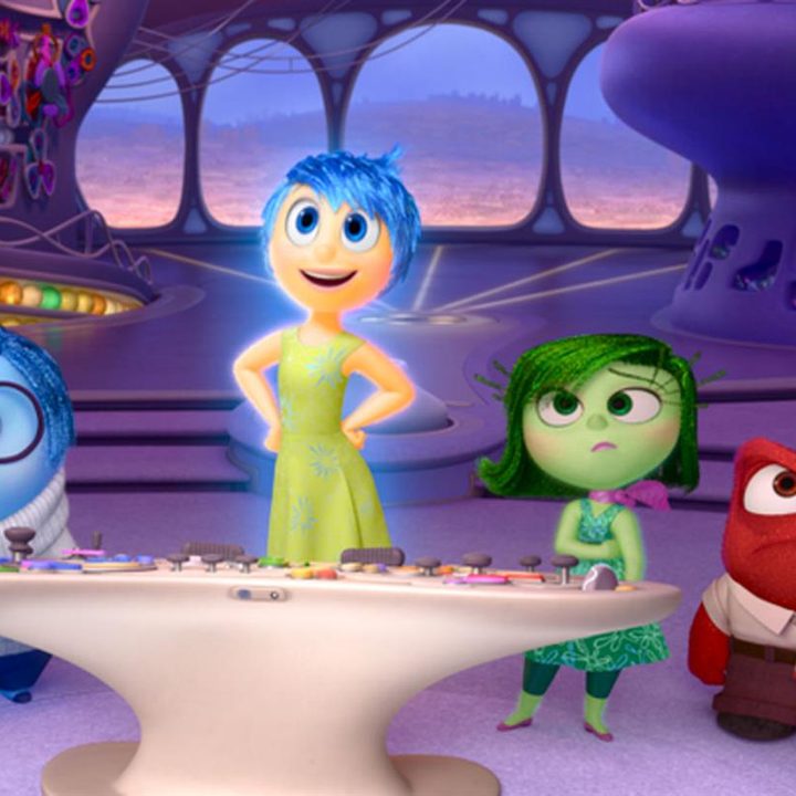 Joy, Sadness, Disgust, and Anger stare into camera in a scene from the Pixar film Inside Out