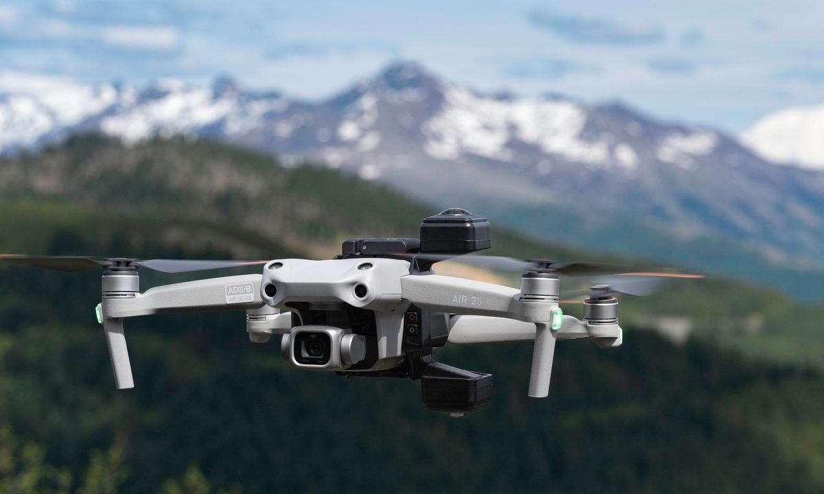The Insta360 Sphere on the DJI Air 2S in flight with mountains in the background.
