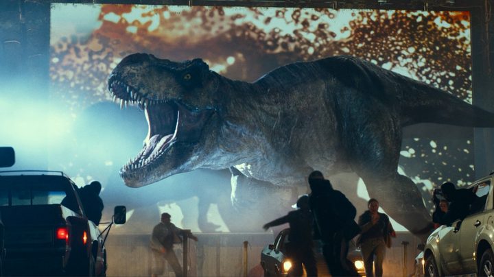 A T-Rex roaring and bursting into a drive-in theater in Jurassic World: Dominion.
