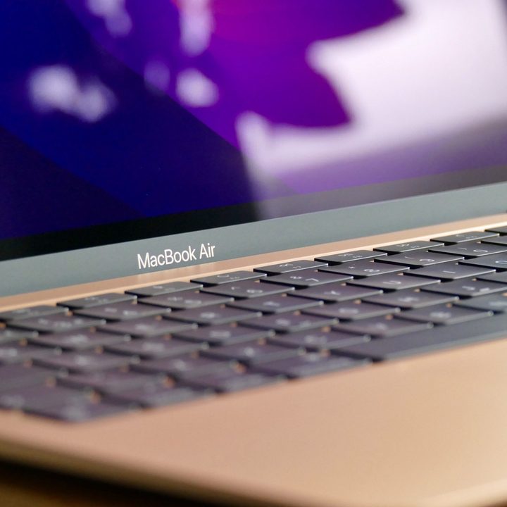 The gold MacBook Air M1's logo and keyboard.