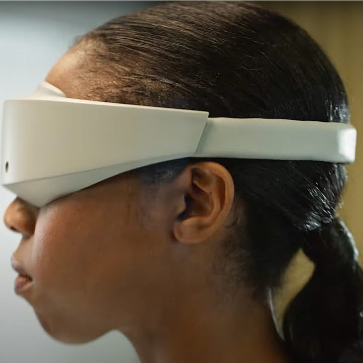 Someone wearing a futuristic VR headset.