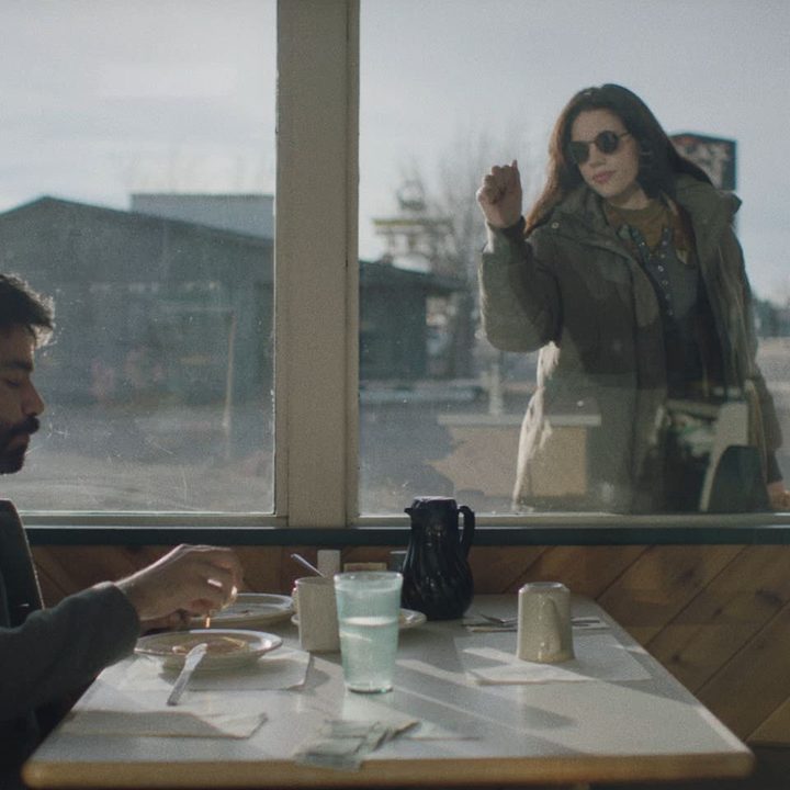 Katie Parker and Rahul Kohli sit at a diner in a scene from Next Exit.
