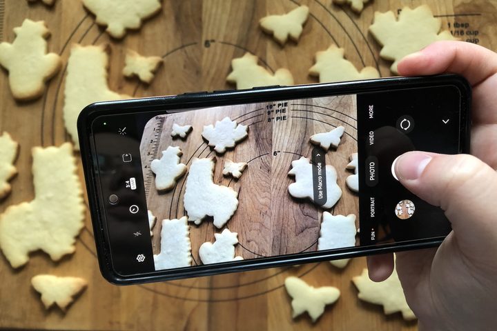 A picture being taken of the two results of the Youtube and TikTok sugar cookies recipes.