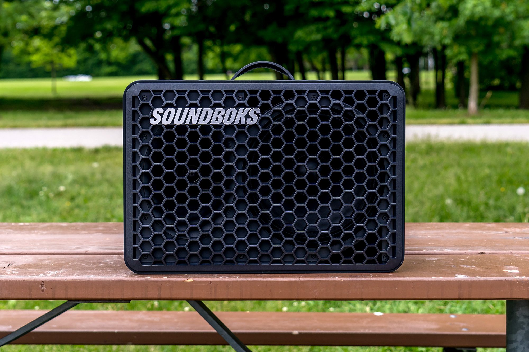The Soundboks Go sitting on top of a picnic table.