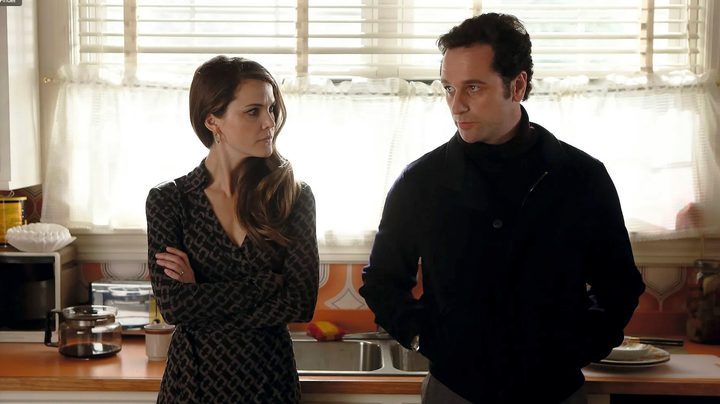Keri Russell and Matthew Rhys stand in a kitchen in The Americans.