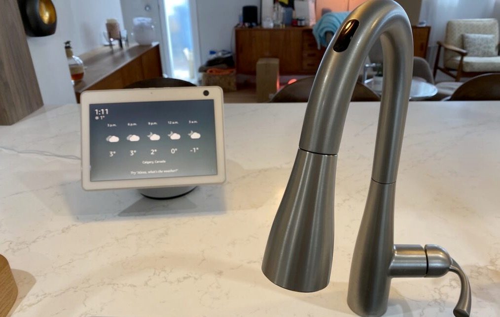 Amazon Alexa speaker sitting next to U by Moen smart tap