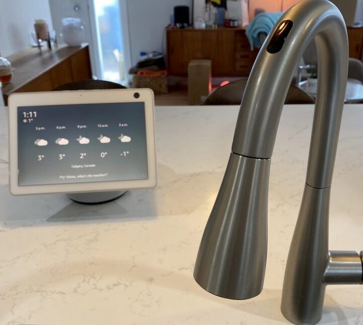Amazon Alexa speaker sitting next to U by Moen smart tap.