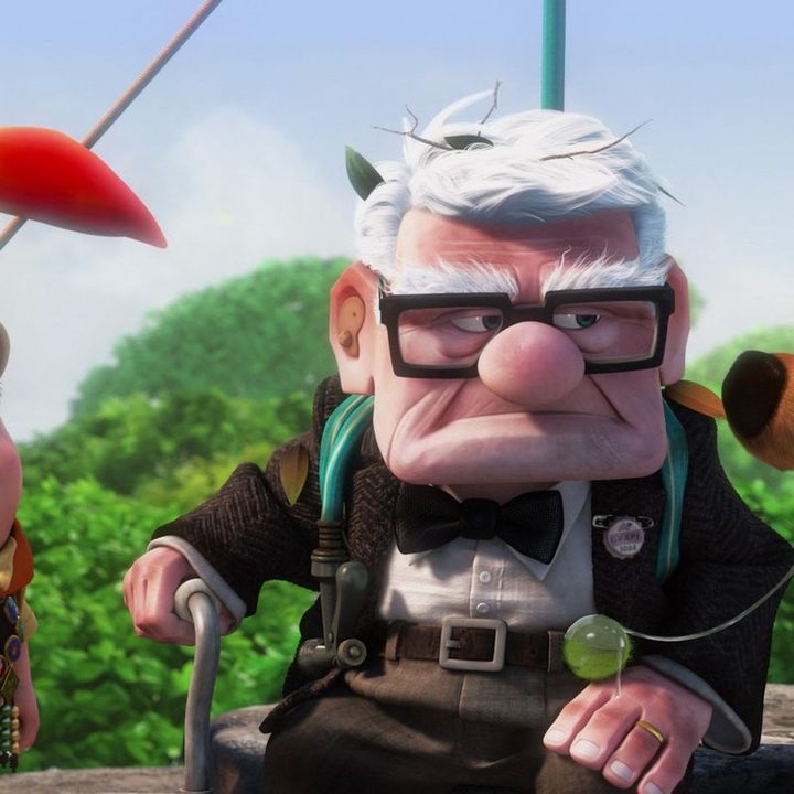 Russell, Dug, and Kevin stand around Carl Fredricksen in a scene from the Pixar film Up