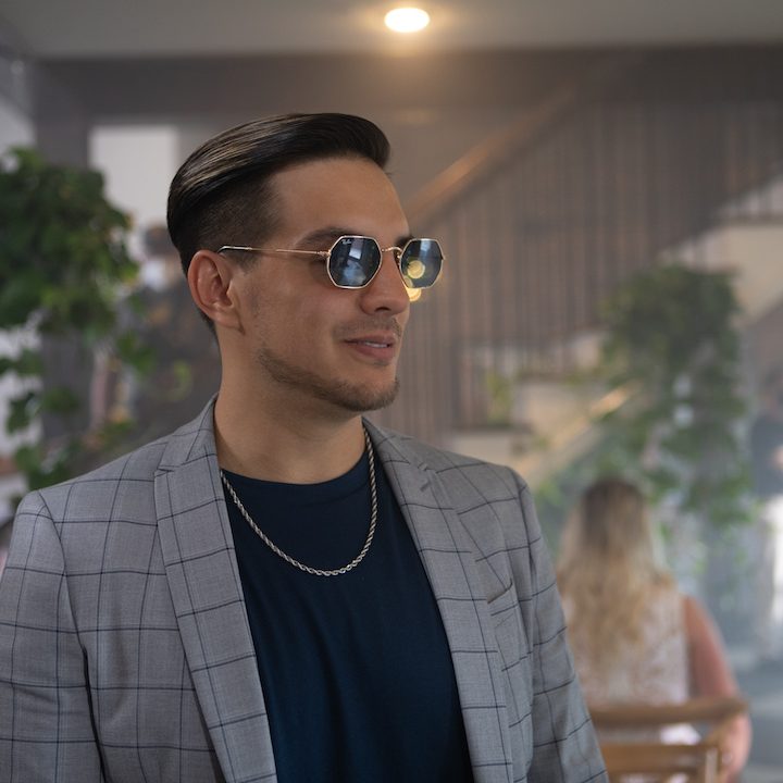 Vadhir Derbez standing and looking in a scene from White Elephant.