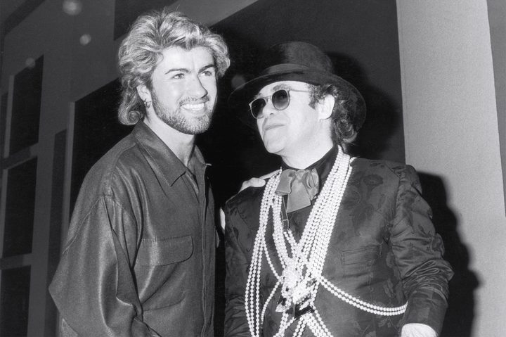 Pop star Elton John (right) congratulates George Michael on winning the Ivor Novello Songwriter of the Year Award at London's Grosvenor House Hotel, 13th March 1985.