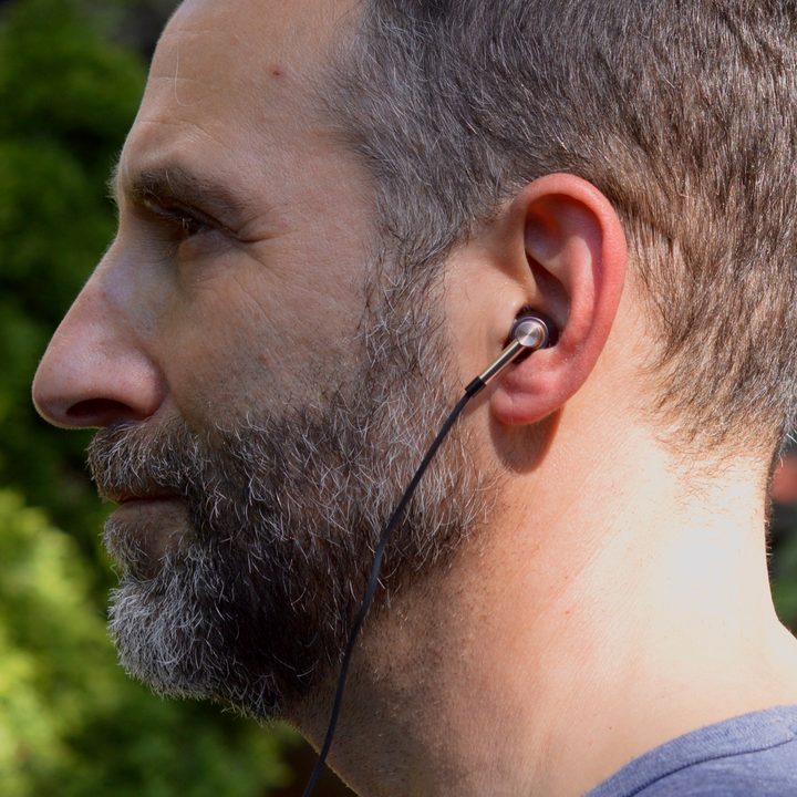 Man wearing the 1More Triple Driver in-ear monitors.