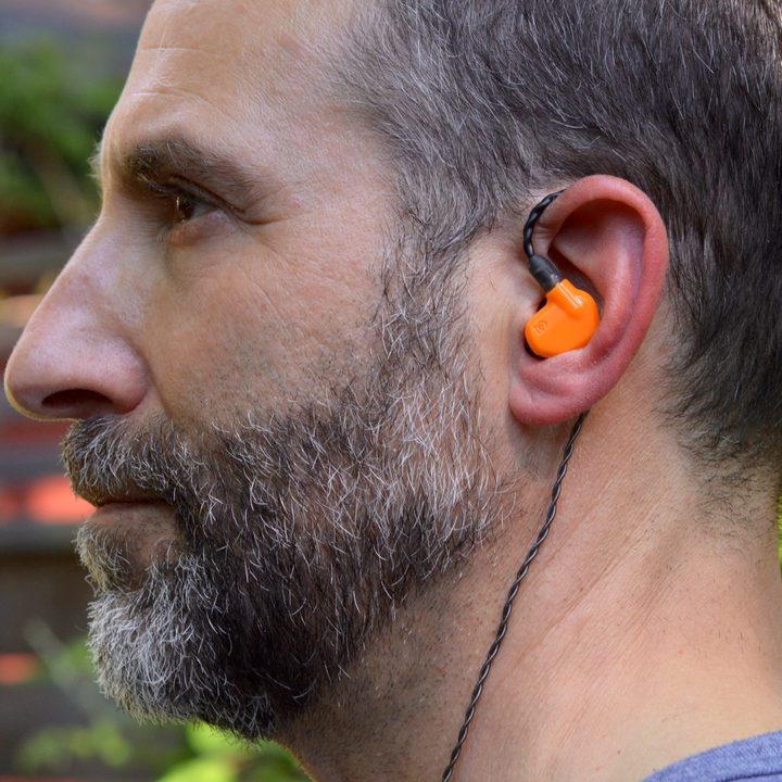Man wearing the Campfire Audio Satsuma in-ear monitors.