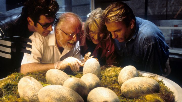 The cast of Steven Spielberg's Jurassic Park look closely at dinosaur eggs.