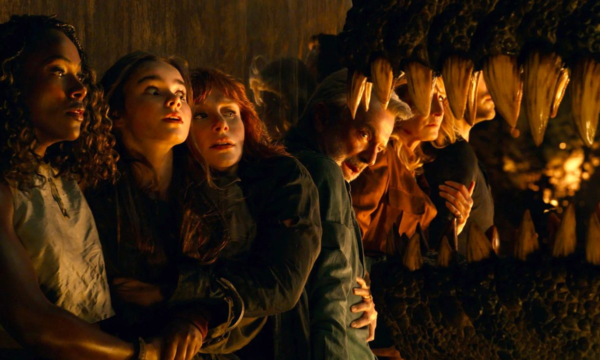 The cast of Jurassic World: Dominion tries to avoid the jaws of a dinosaur attempting to reach them.