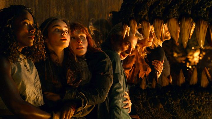 The cast of Jurassic World: Dominion tries to avoid the jaws of a dinosaur attempting to reach them.
