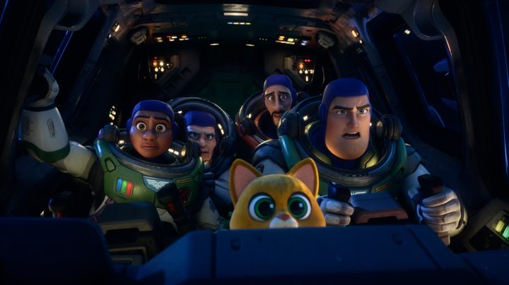 A view inside the cockpit of a crowded ship in Lightyear, with Buzz piloting it.