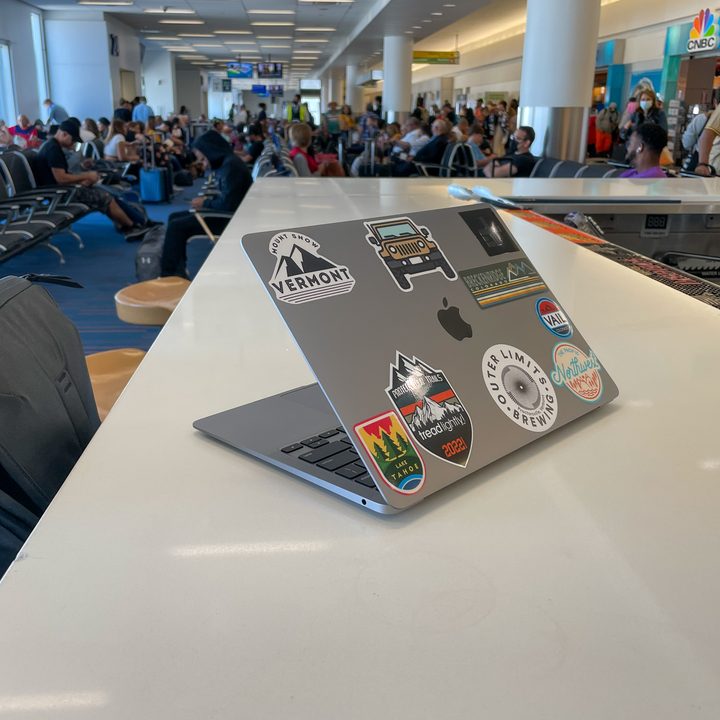 MacBook Air sitting on a table in an airport.