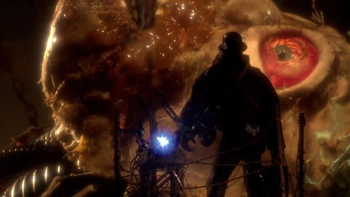 The Assassin stands in front of a giant creature being tortured in a scene from Mad God.