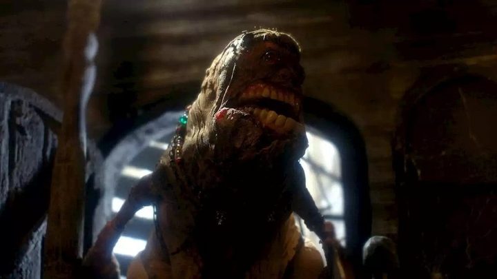 A creature shambles out of a cave in a scene from Mad God.