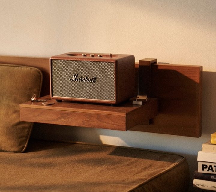 The Marshall third-gen home speaker sitting on a bedside table.