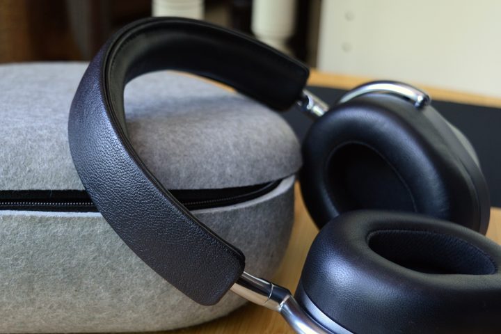 Master & Dynamic MW75 leaning against their carry case