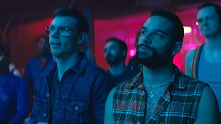 Julian and Noah look at a stage performance in 2022's Queer as Folk.