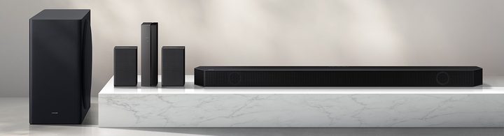 Samsung HW-Q910B soundbar with remote, rear speakers, and wireless subwoofer.