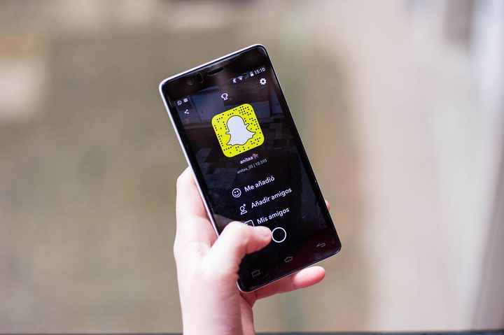 A person using Snapchat on an iPhone.
