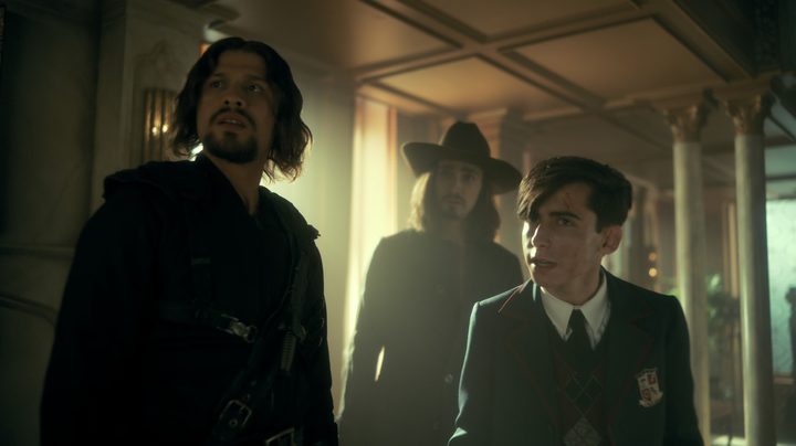 David Castañeda, Robert Sheehan, and Aidan Gallagher stare off to the left of the frame in a scene from The Umbrella Academy season 3.