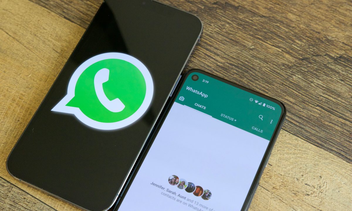 Two phones on a table next to each other. One is showing the WhatsApp logo, and the other is running the WhatsApp application.