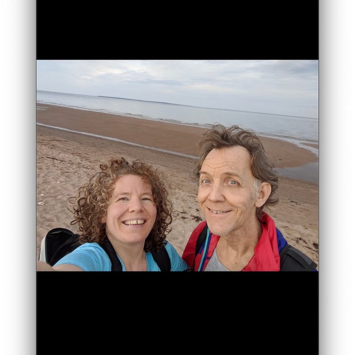A Google Pixel 6a selfie showing a couple on the beach.