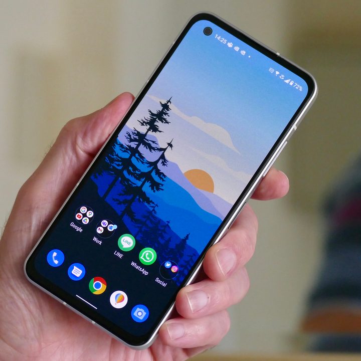 The Asus Zenfone 9 held in hand, showing the screen.