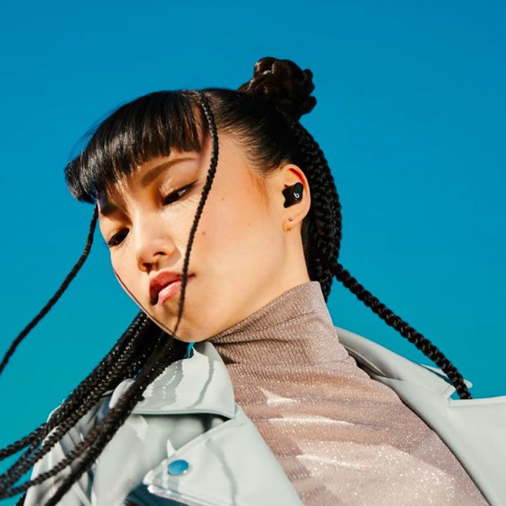 A woman listens to music on her Beats Studio Buds.