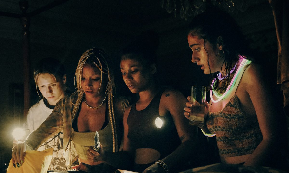 Bee, Sophie, Jordan, and Alice stand in the dark together in Bodies Bodies Bodies.