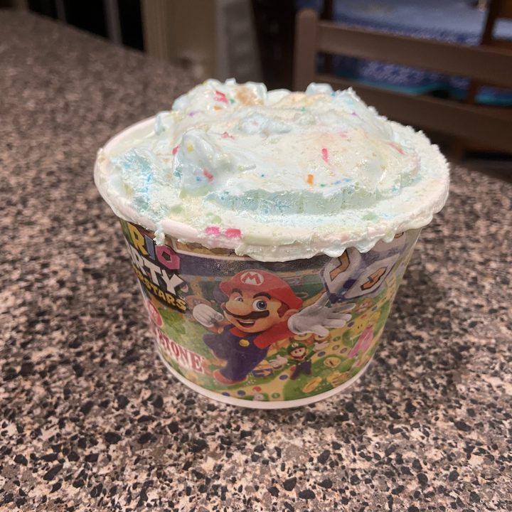 Cold Stone's Mario ice cream sits in a container.