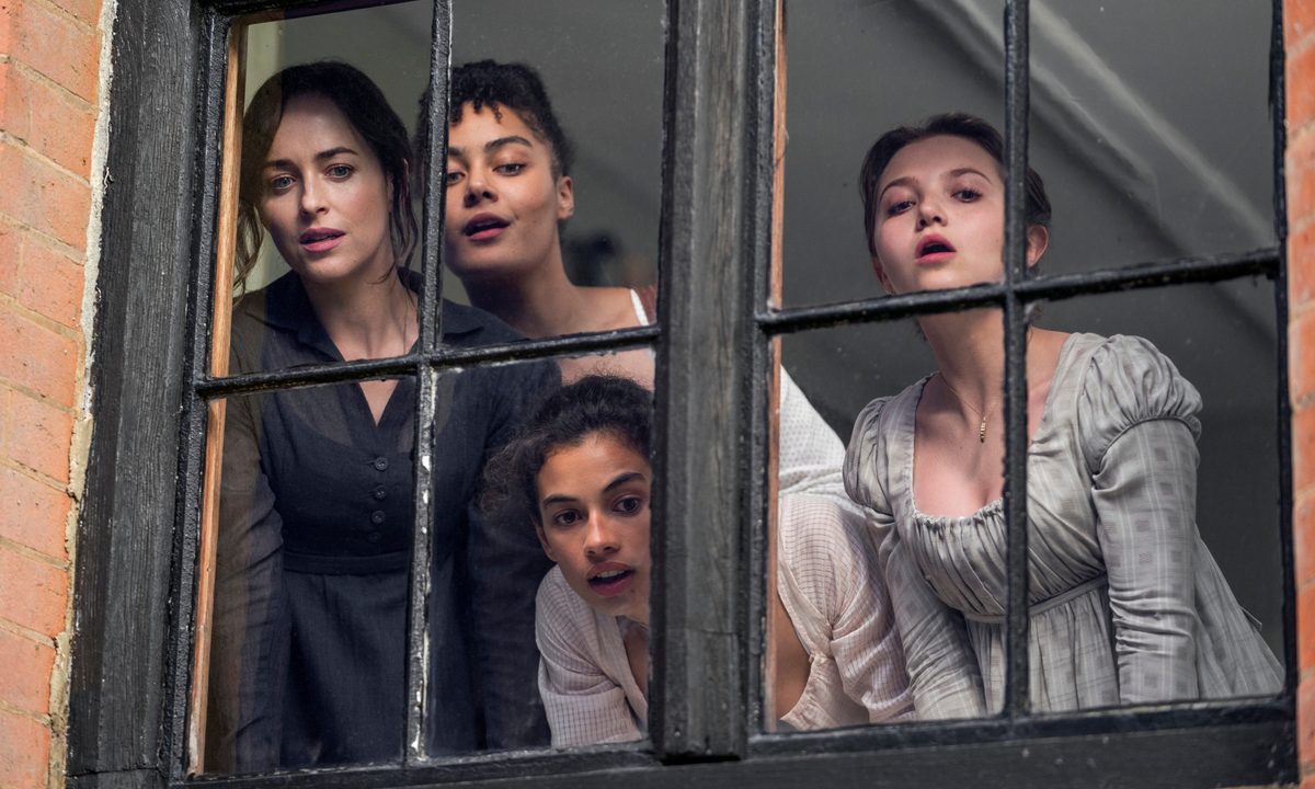 The Elliot and Musgrove sisters look through a window together in Netflix's Persuasion.