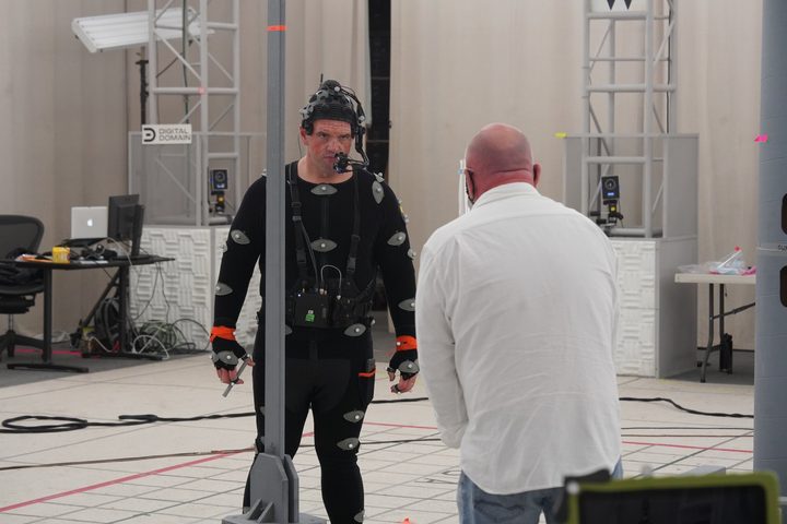 Ethan Suplee, in a performance-capture suit, stares at the camera, with The Quarry director Will Byles in the foreground.