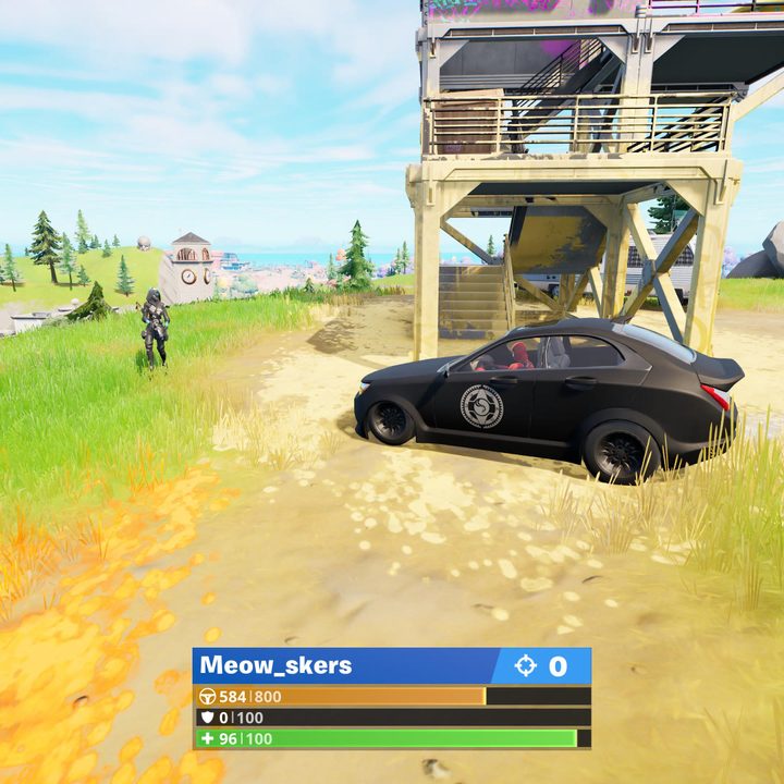 Car driving toward enemy in Fortnite.