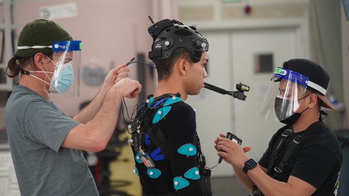Justice Smith gets his head-mounted camera checked while filming The Quarry game.