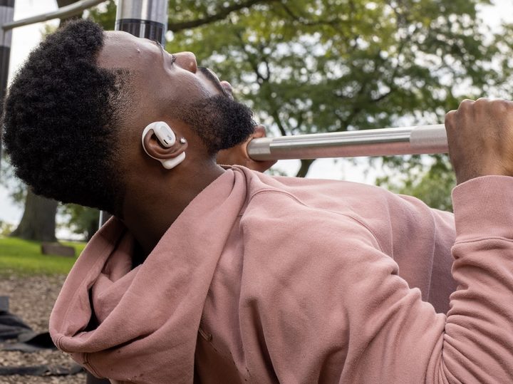 Oladance OWS open ear headphones worn during workout.