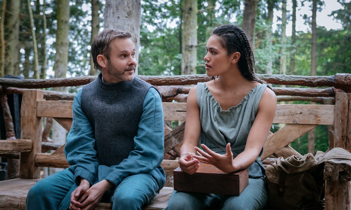Paul and Bella look at each other in Moonhaven.