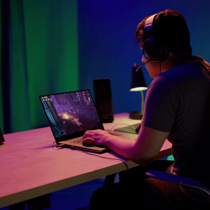 Playing games with GeForce Now on a laptop.